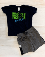 Load image into Gallery viewer, The word &quot;kindness&quot; stacked three times in neon green vinyl, the word &quot;spread&quot; in bright blue vinyl across the word &quot;kindness&quot; so that the shirt reads &quot;spread Kindness&quot;
